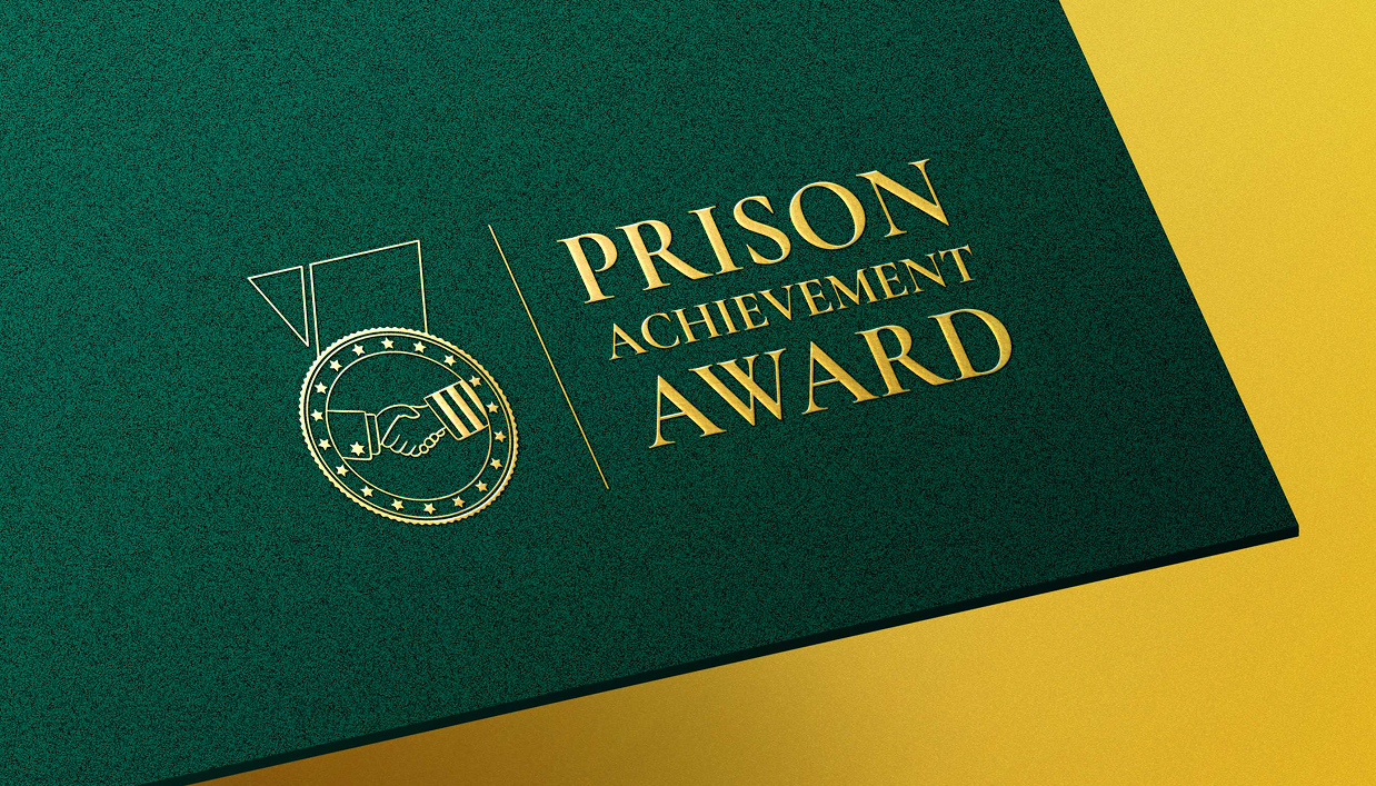 Prison Achievement Award identity on a green and gold presentation folder